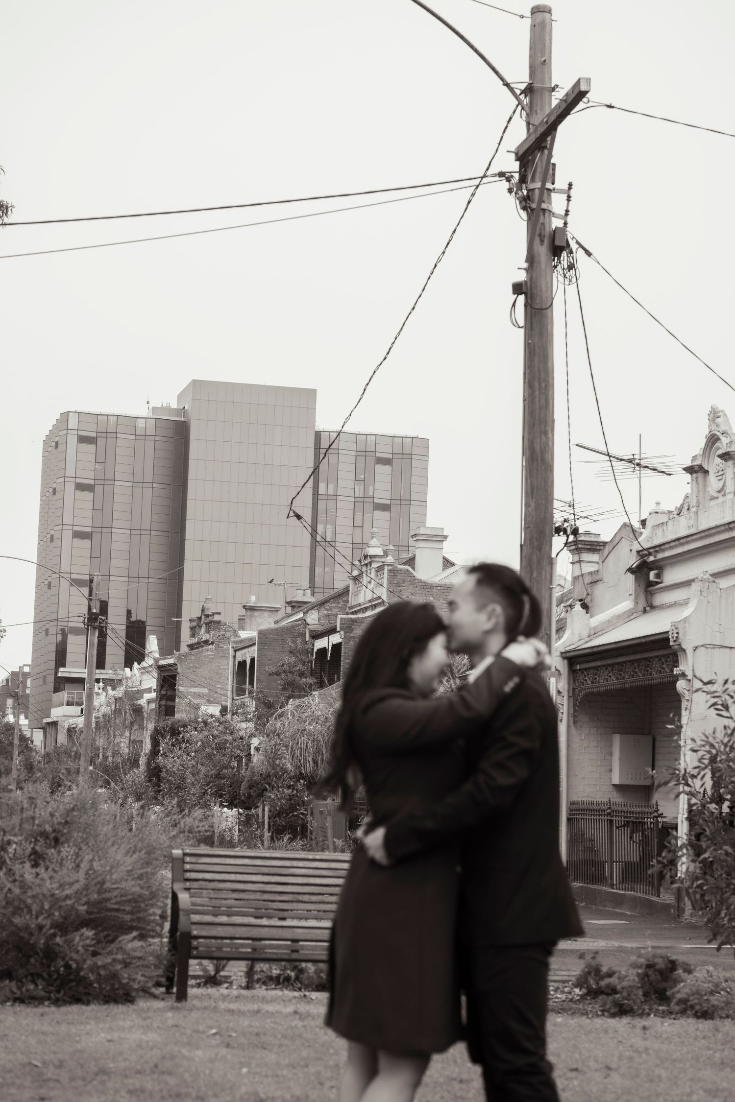 Couple wandering through Melbourne's city streets during their engagement session.