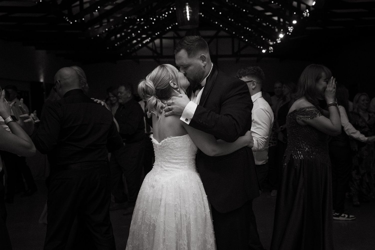 Black and white photo of bride and groom sharing first dance embrace at Simbali Lodge wedding reception in Pretoria