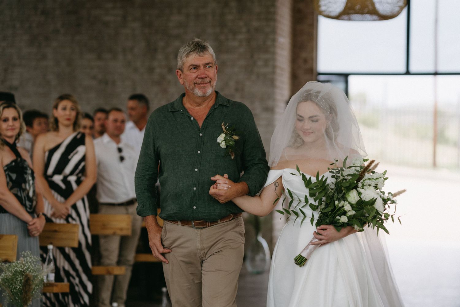 A traditional wedding processional moment showing a procession down the aisle with a beautiful bouquet.