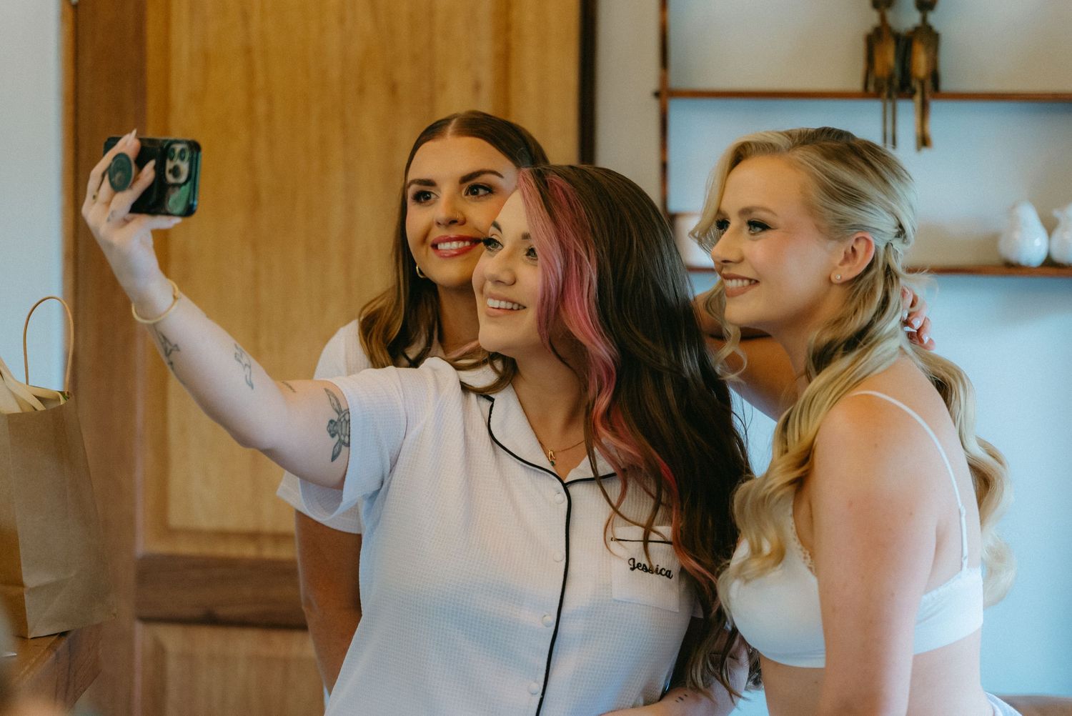 Wedding party members getting ready in matching white outfits.