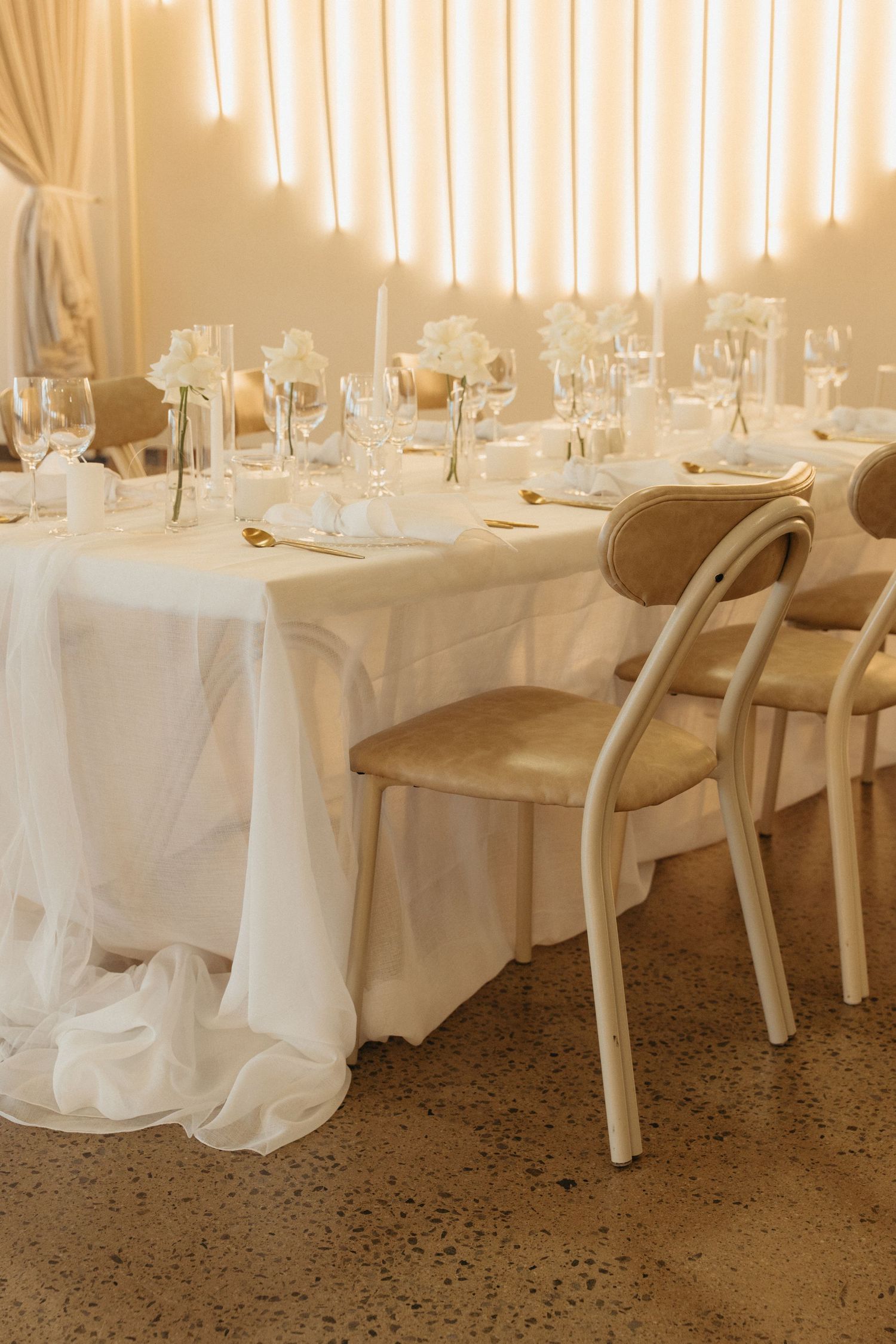 Elegant wedding reception table set  at Bona Bona Lodge with white linens, crystal glasses, and warm ambient lighting.