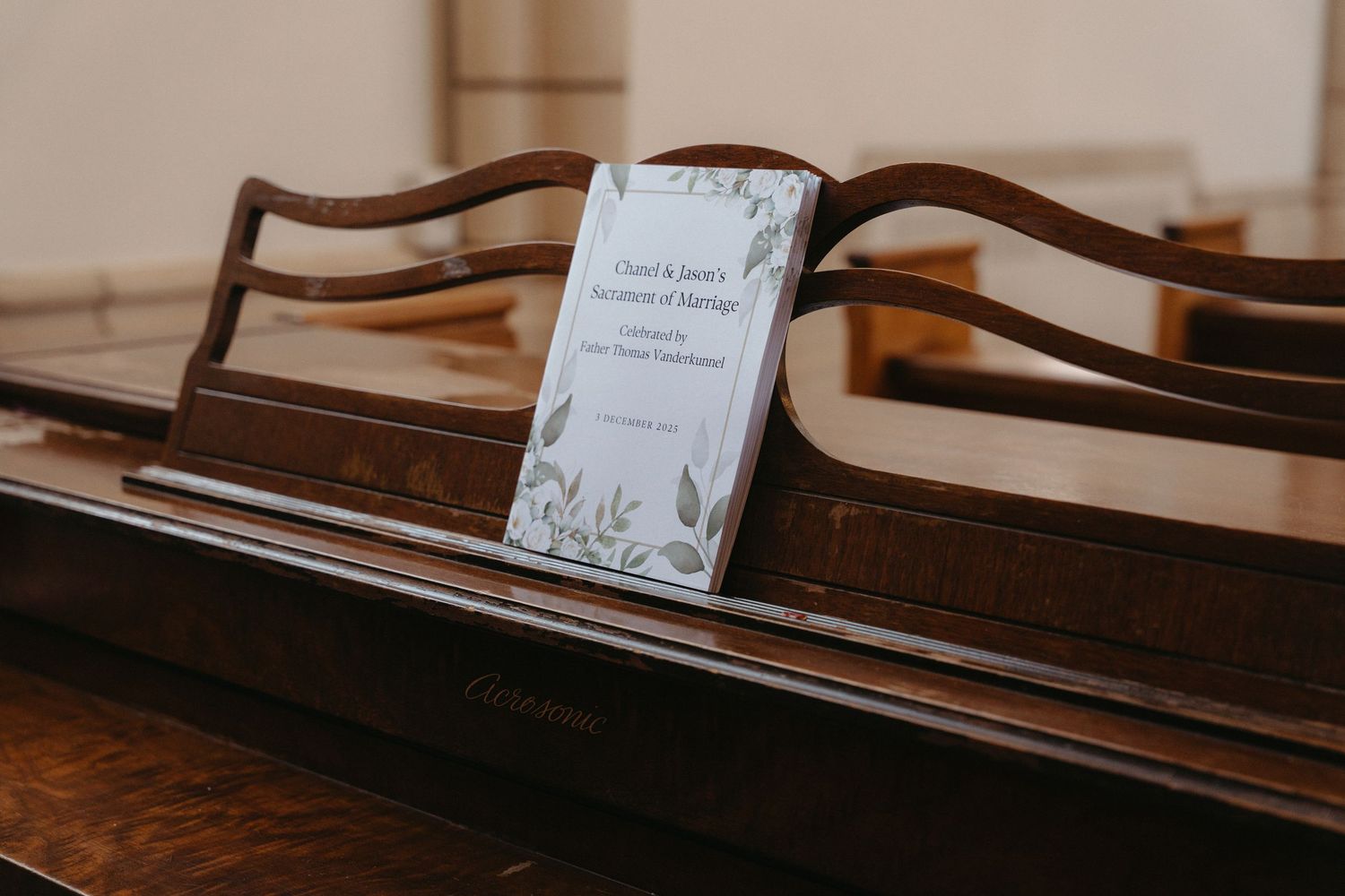White wedding program on a piano at Nazareth House Chapel, Pretoria