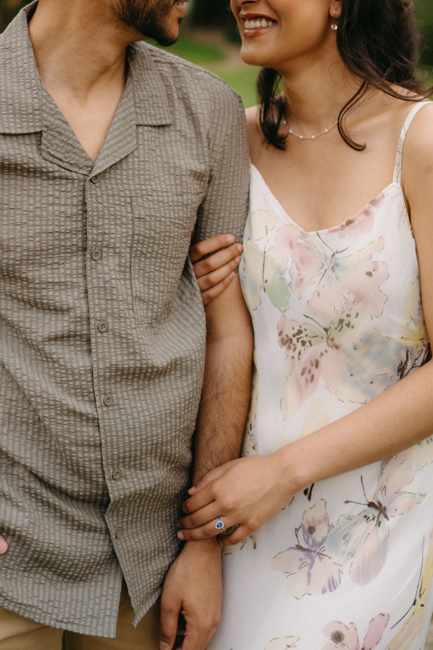 Close-up detail of a couple in coordinating outfits showing gentle affection.