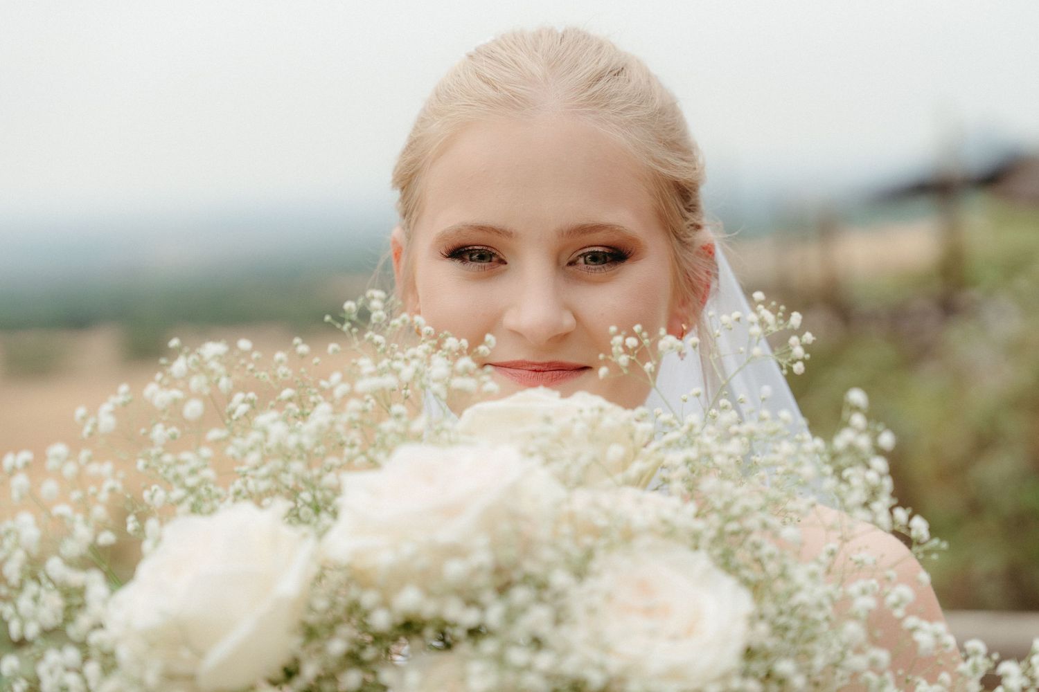 Delicate baby's breath flowers frame a soft, romantic wedding portrait.