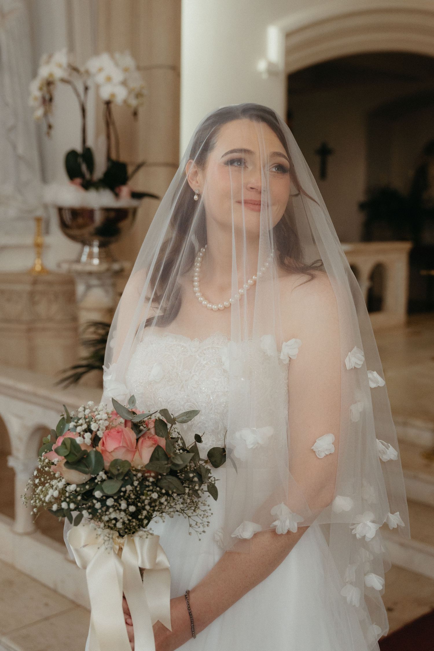 A bridal portrait series showing a delicate veil with floral appliques and pearl jewellery at Nazareth House Pretoria