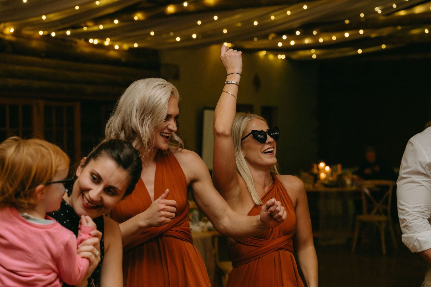 Wedding reception venue decorated with warm string lights creating a romantic ambiance.
