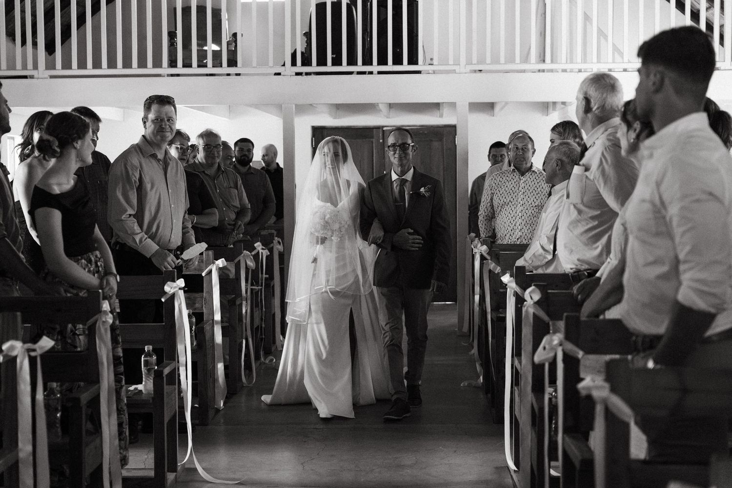 Wedding guests dance together in an elegant reception hall during an evening celebration.