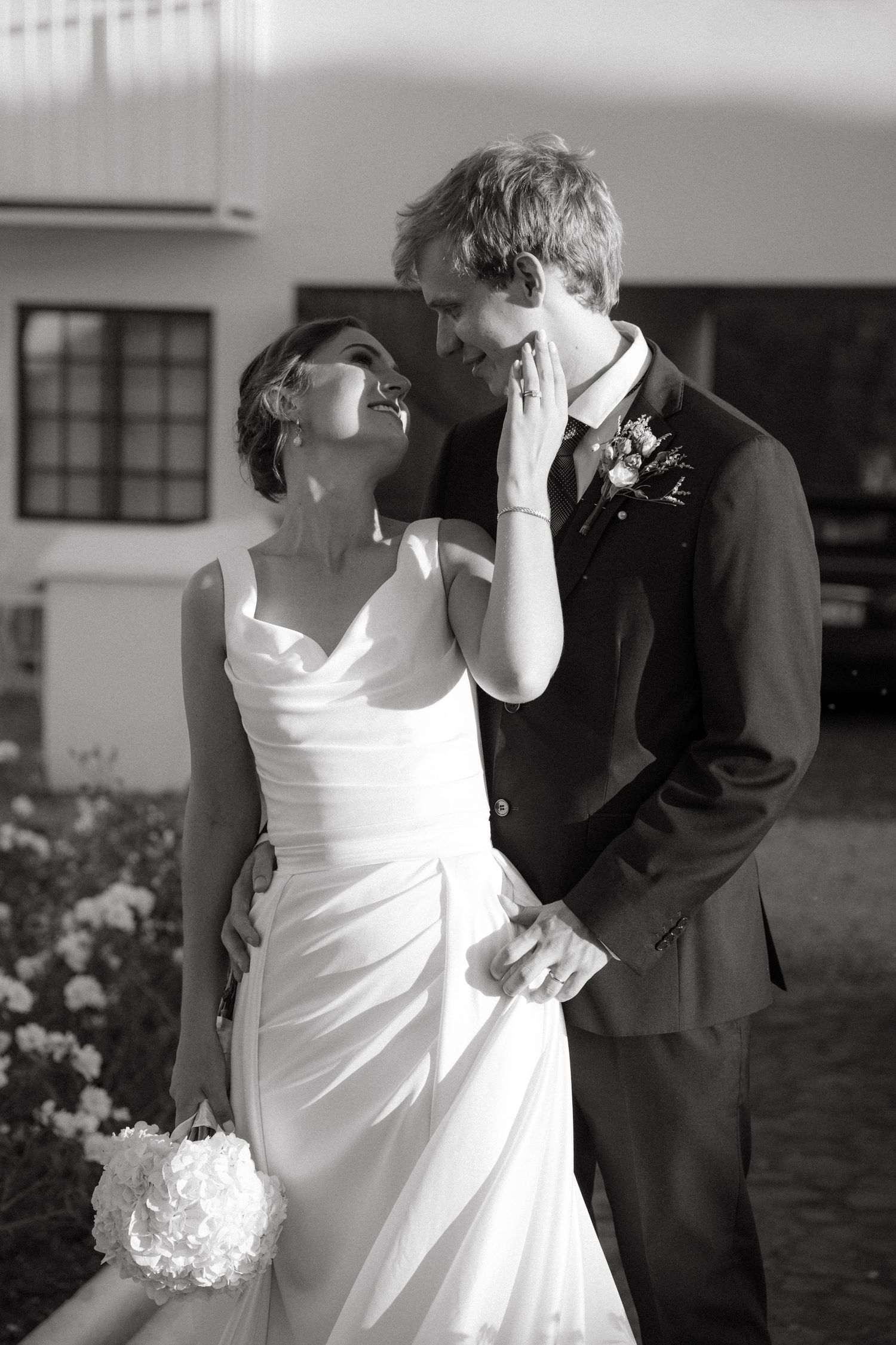 A romantic black and white wedding photo series showing a couple dancing and embracing in formal attire.