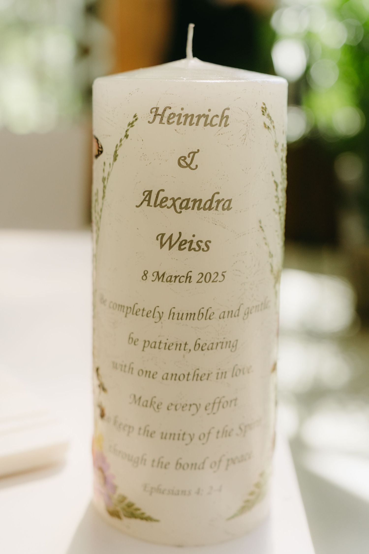 A decorative wedding unity candle featuring names Heinrich and Alexandra Weiss with a Bible verse and March 2025 date.