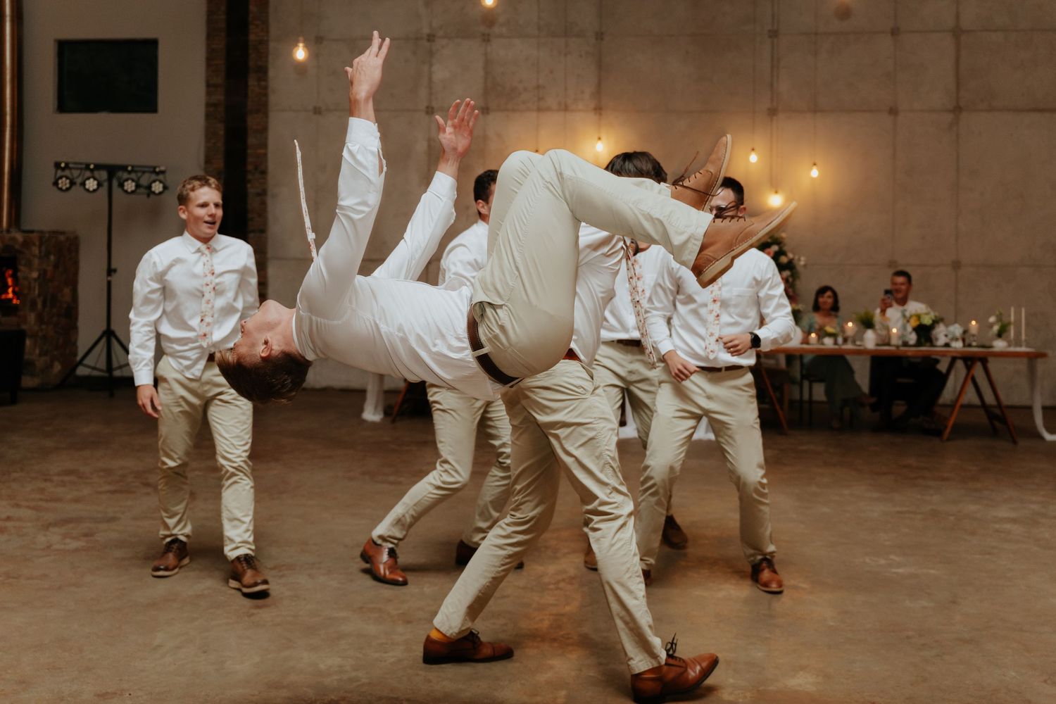 A sequence of dance moves shows two people in white outfits performing a choreographed swing dance routine.