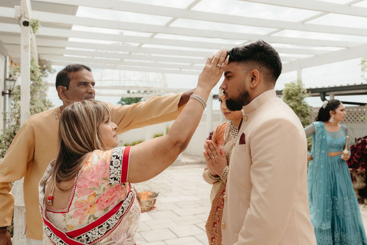 A series of candid moments from a traditional Indian wedding celebration showing guests dancing and interacting.