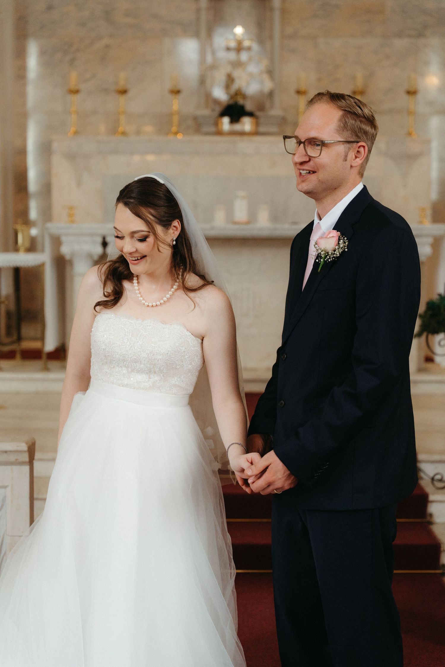 A couple shares tender moments during their wedding ceremony in the elegant church setting of Nazareth House Chapel
