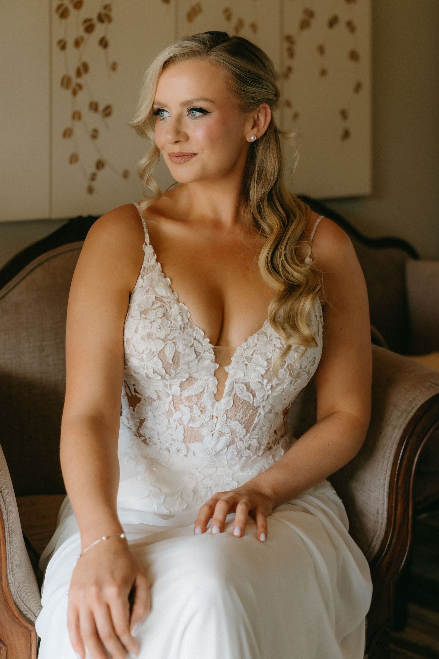 Wedding dress detail showing intricate white lace bodice and delicate embroidery.