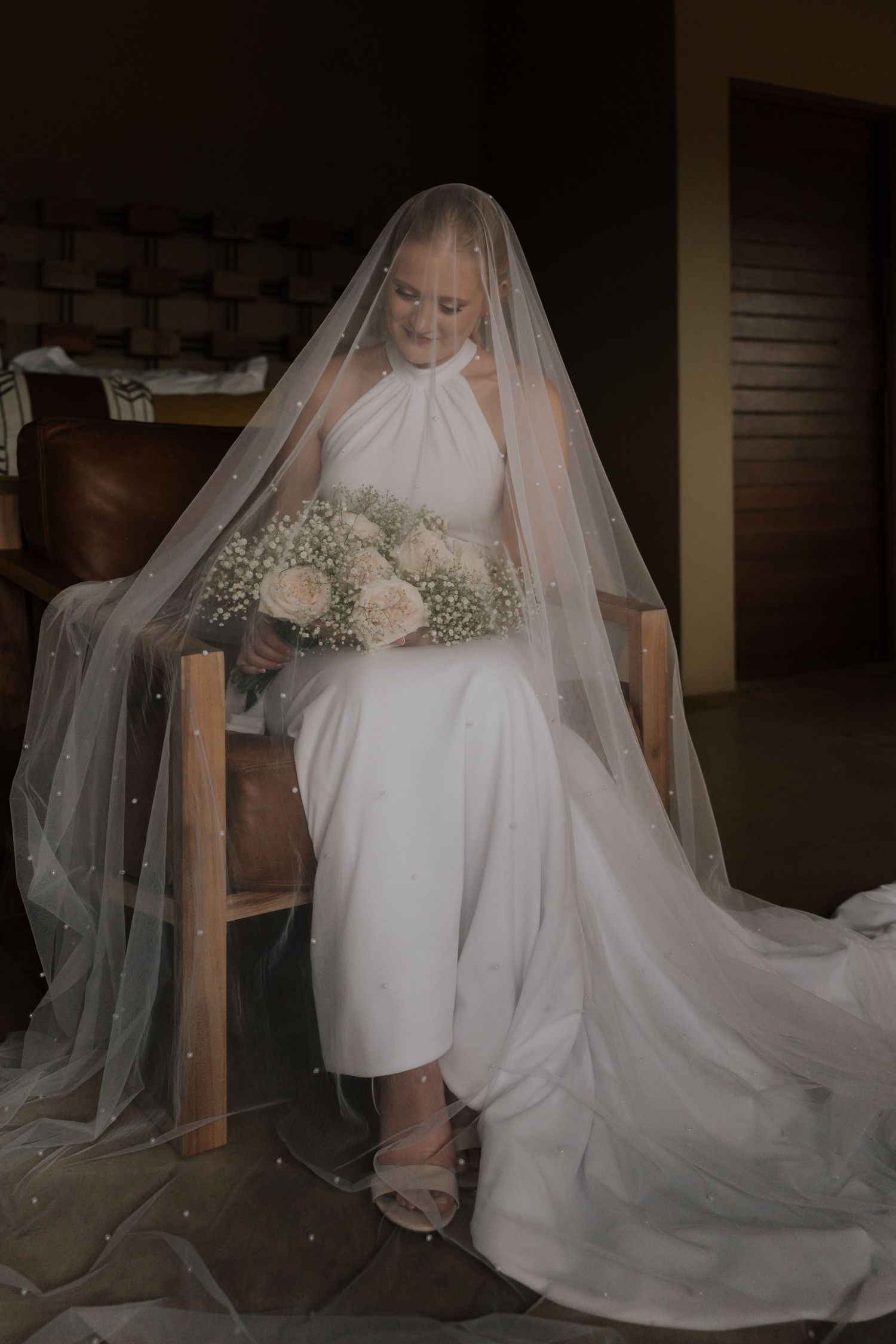 A series of bridal portraits showing a flowing white wedding dress and veil in different angles and poses.