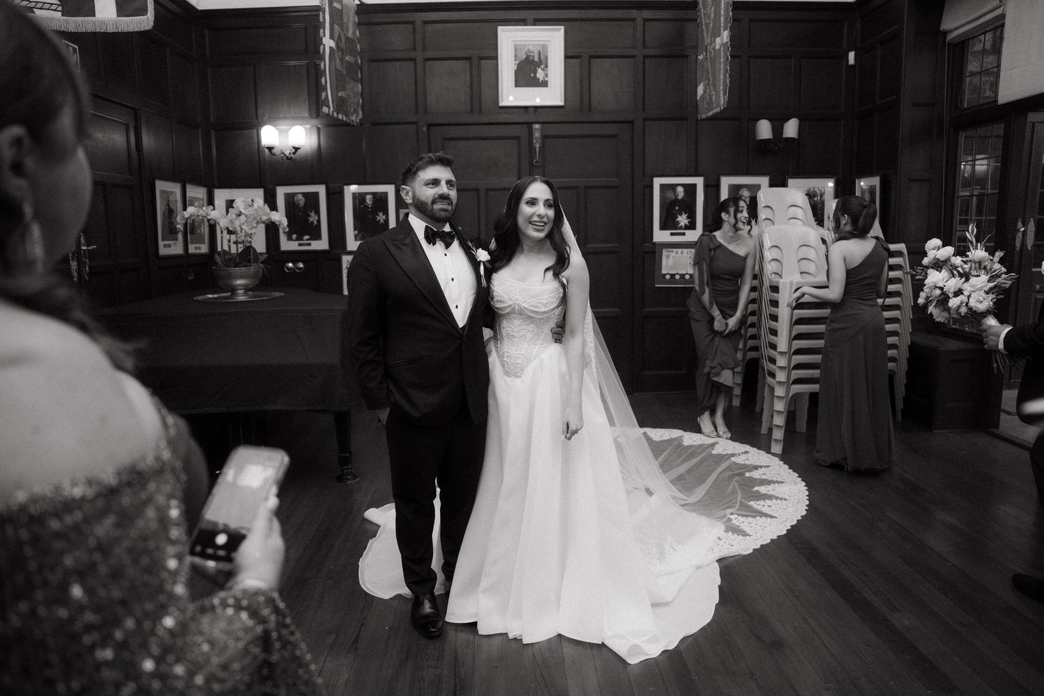Black and white photo of a bride and groom standing together in an elegant wood-paneled room at Glenshiel in Johannesburg.