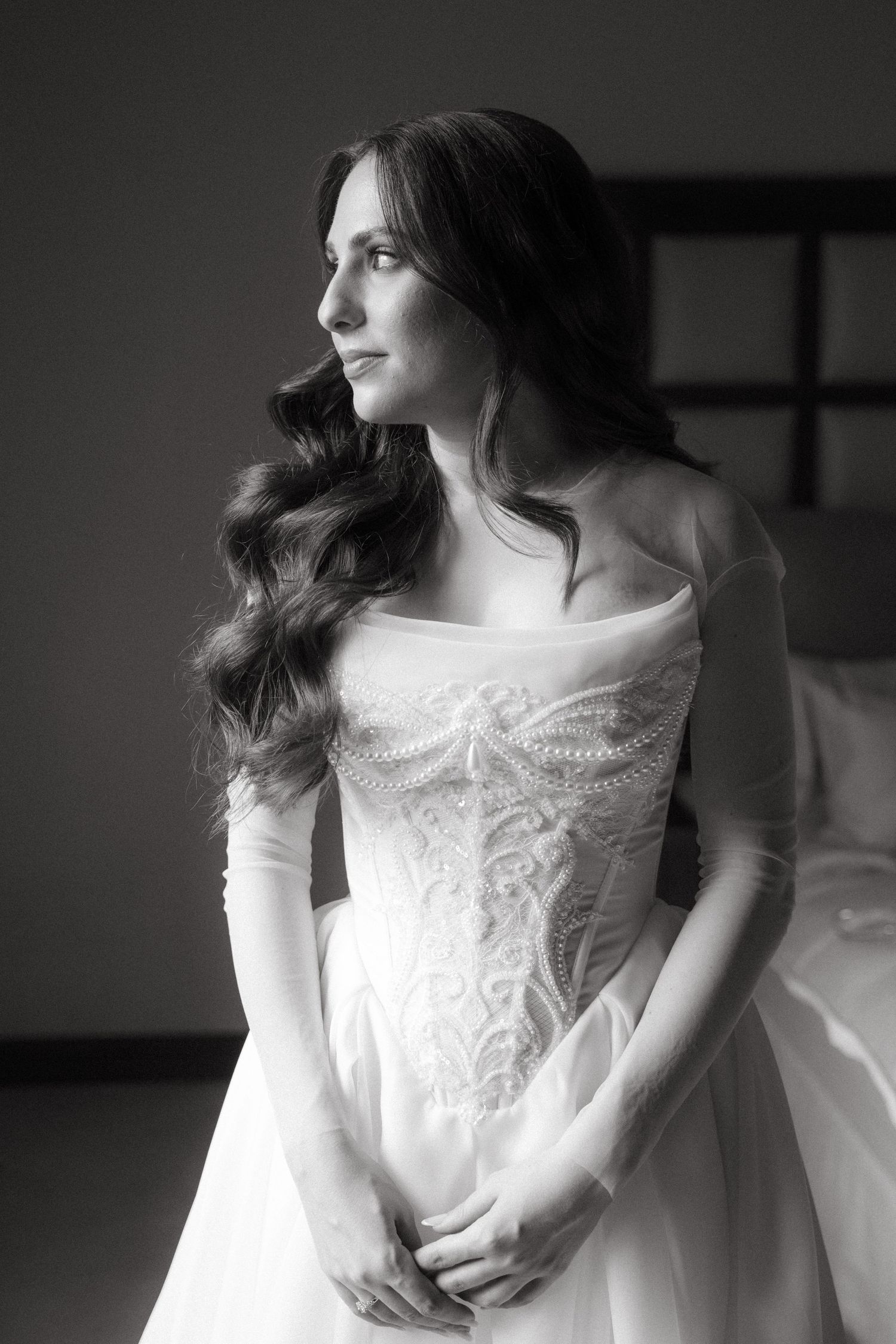 Black and white portrait of brunette bride in strapless lace corset wedding gown gazing sideways in Johannesburg