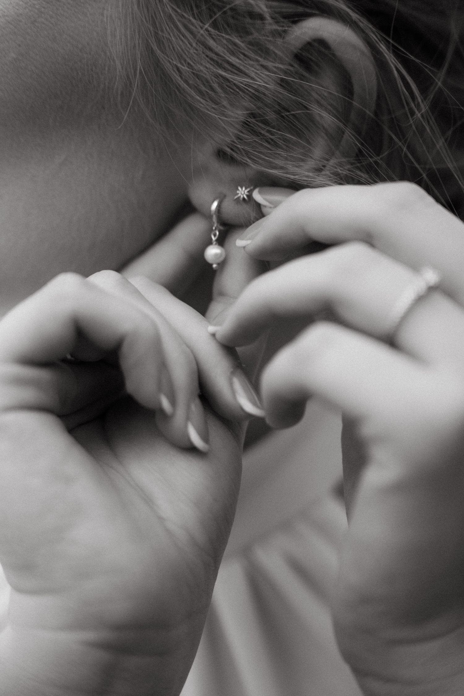 Artistic black and white close-up of wedding day jewelry and details.