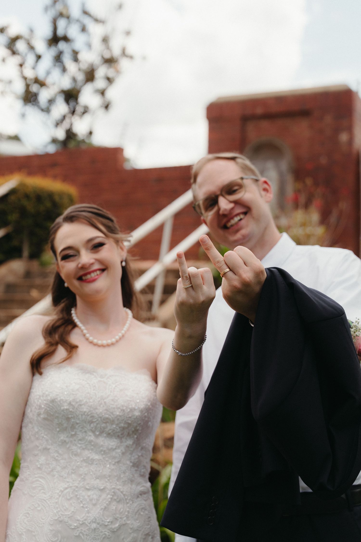 A joyful couple shares candid moments together during their outdoor wedding photo session.