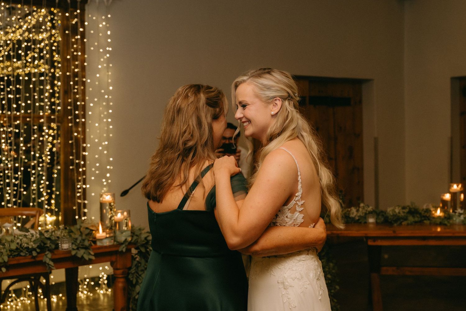 Wedding reception celebration with string lights creating warm ambiance indoors.