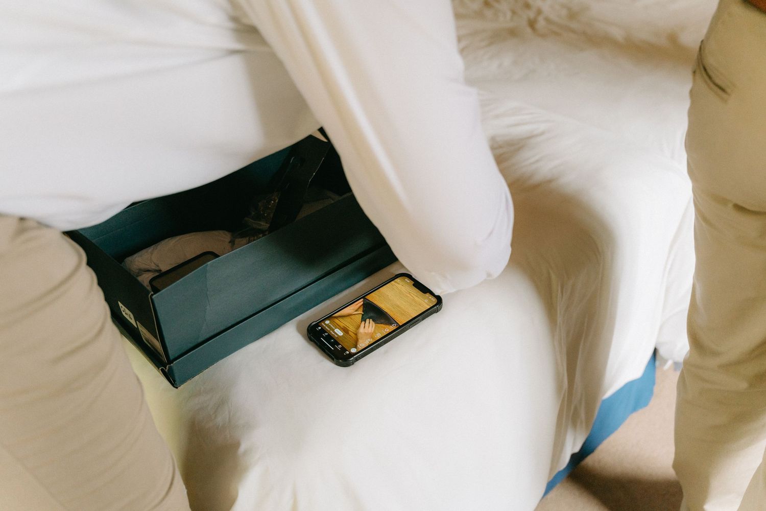 Wedding preparation details with formal white attire and accessories.