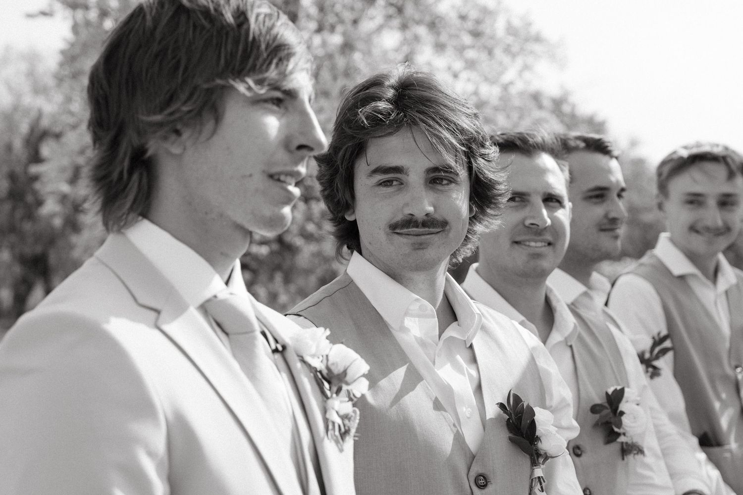 Groom and groomsmen smile in black and white outdoor wedding portrait at Mountain View Game Lodge in Limpopo