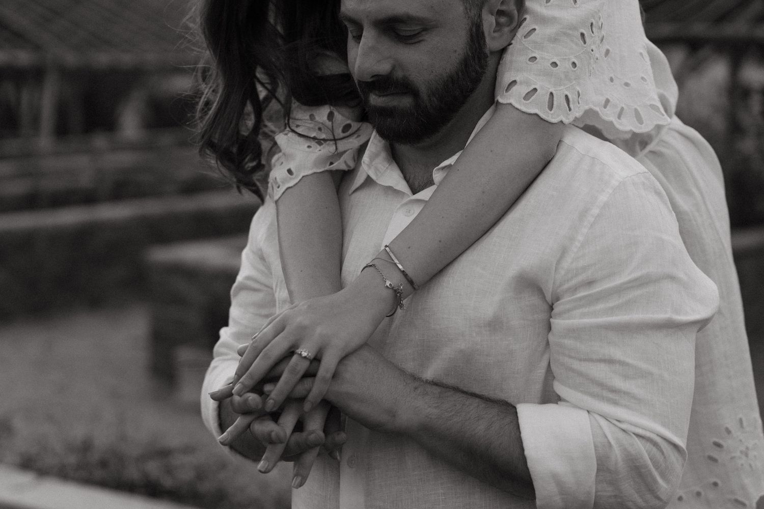 Black and white photos capture tender moments between couple during outdoor engagement session.