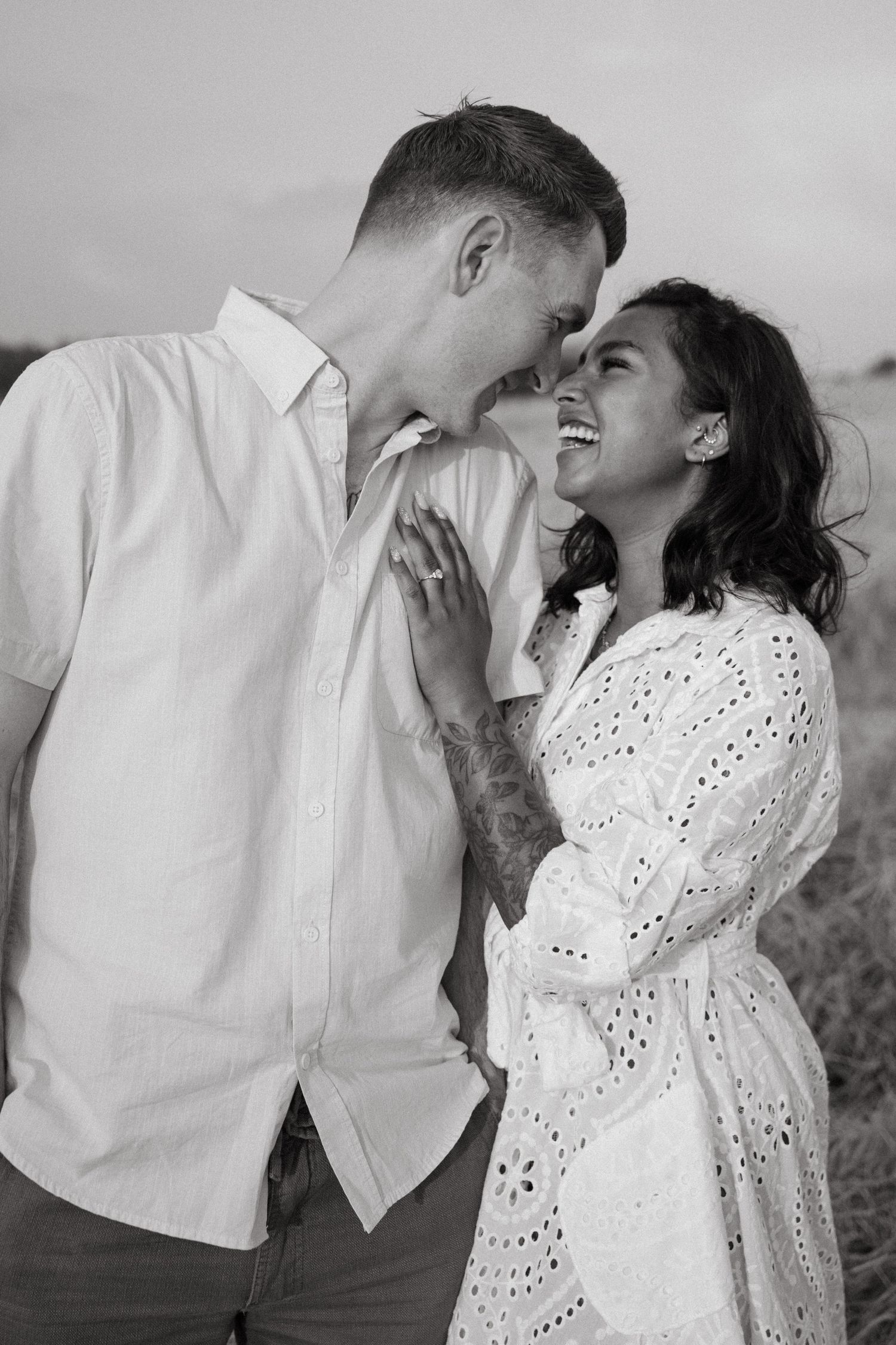Series of candid black and white photos showing a couple laughing and embracing outdoors.