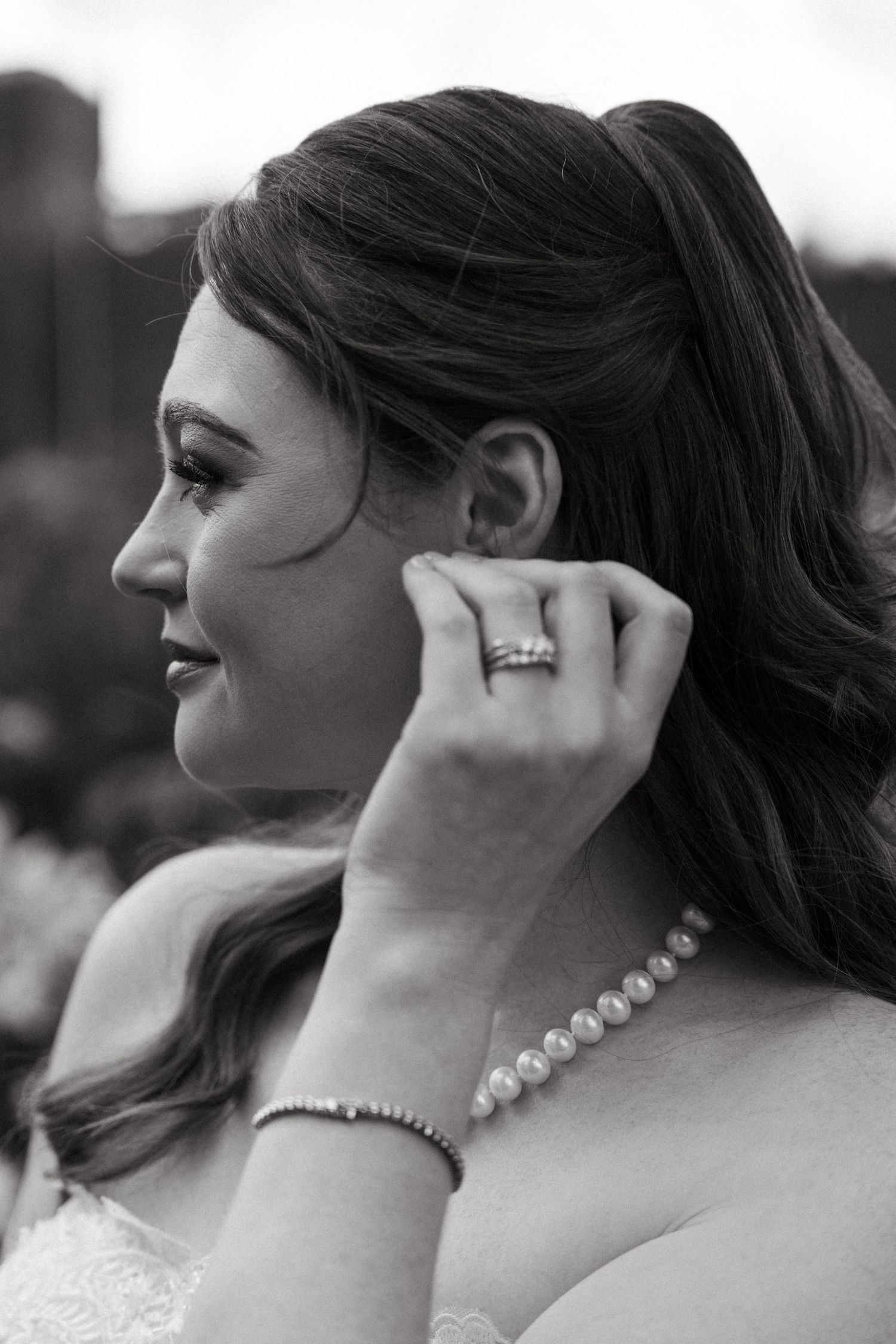 A black and white series of photos showing close-up details of pearl earrings and necklace on a bride.