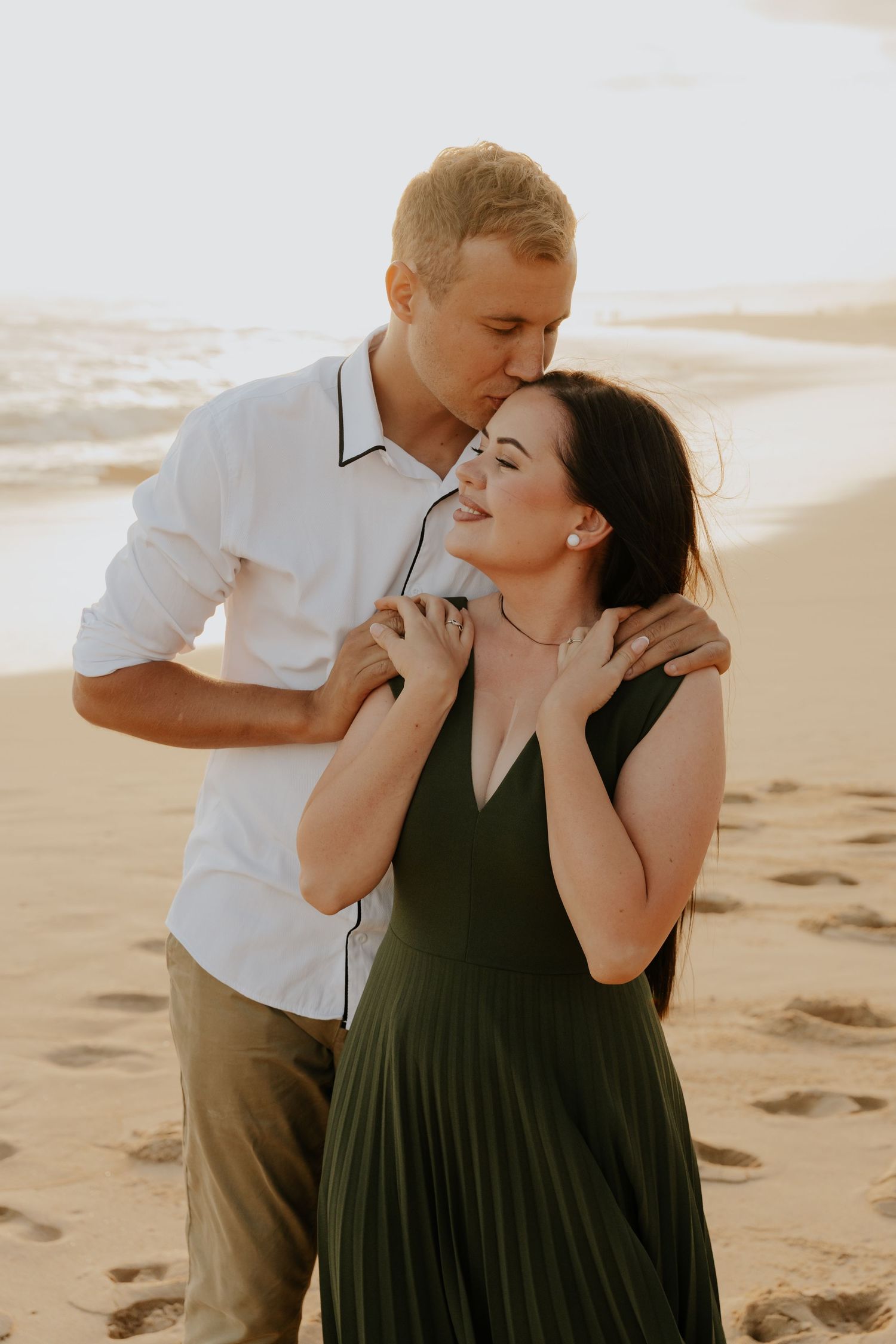 A couple shares intimate moments and laughter together during a sunset photoshoot in Mossel Bay, Western Cape