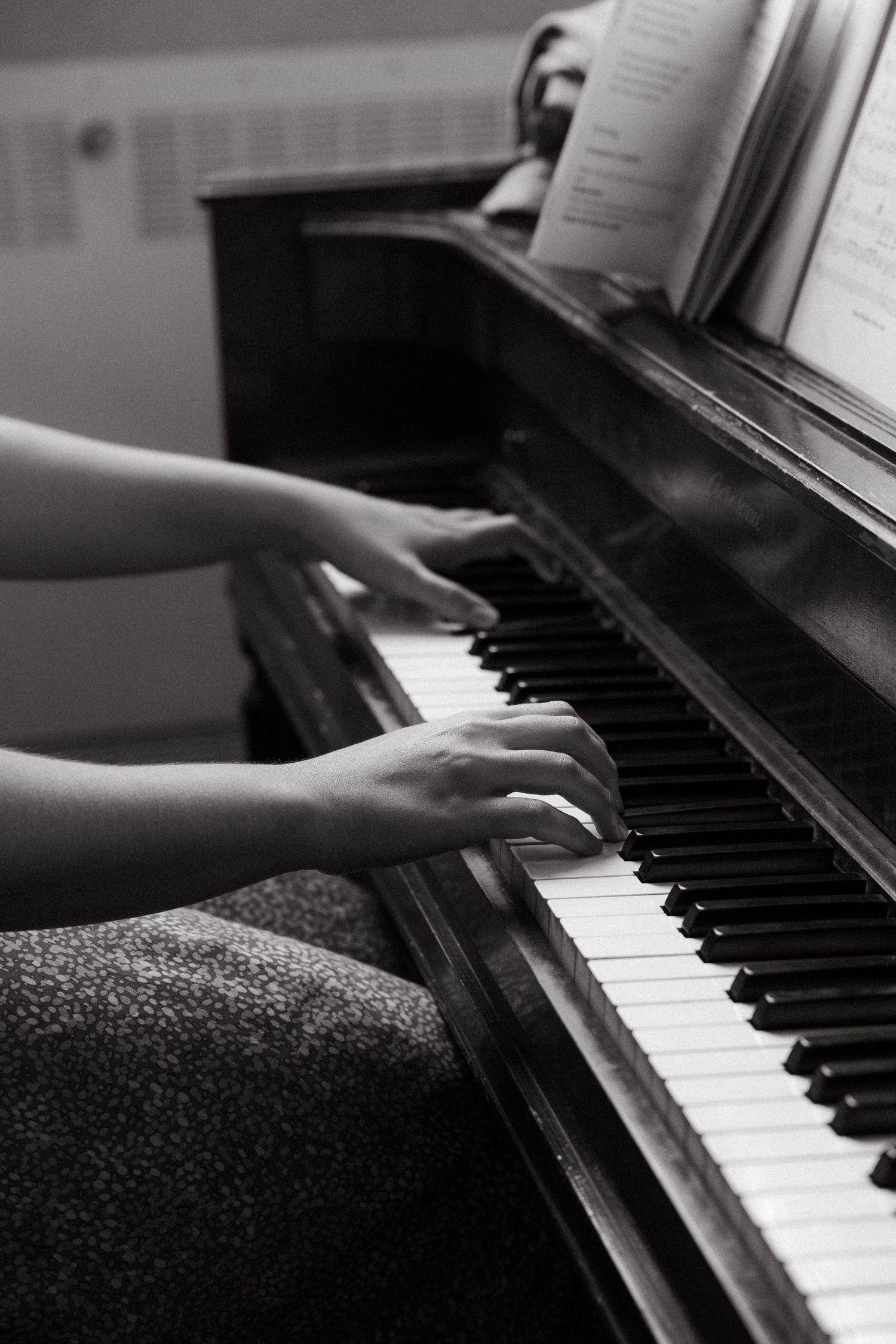 A black and white collage of piano keys and hands playing the piano in various close-up angles in Pretoria