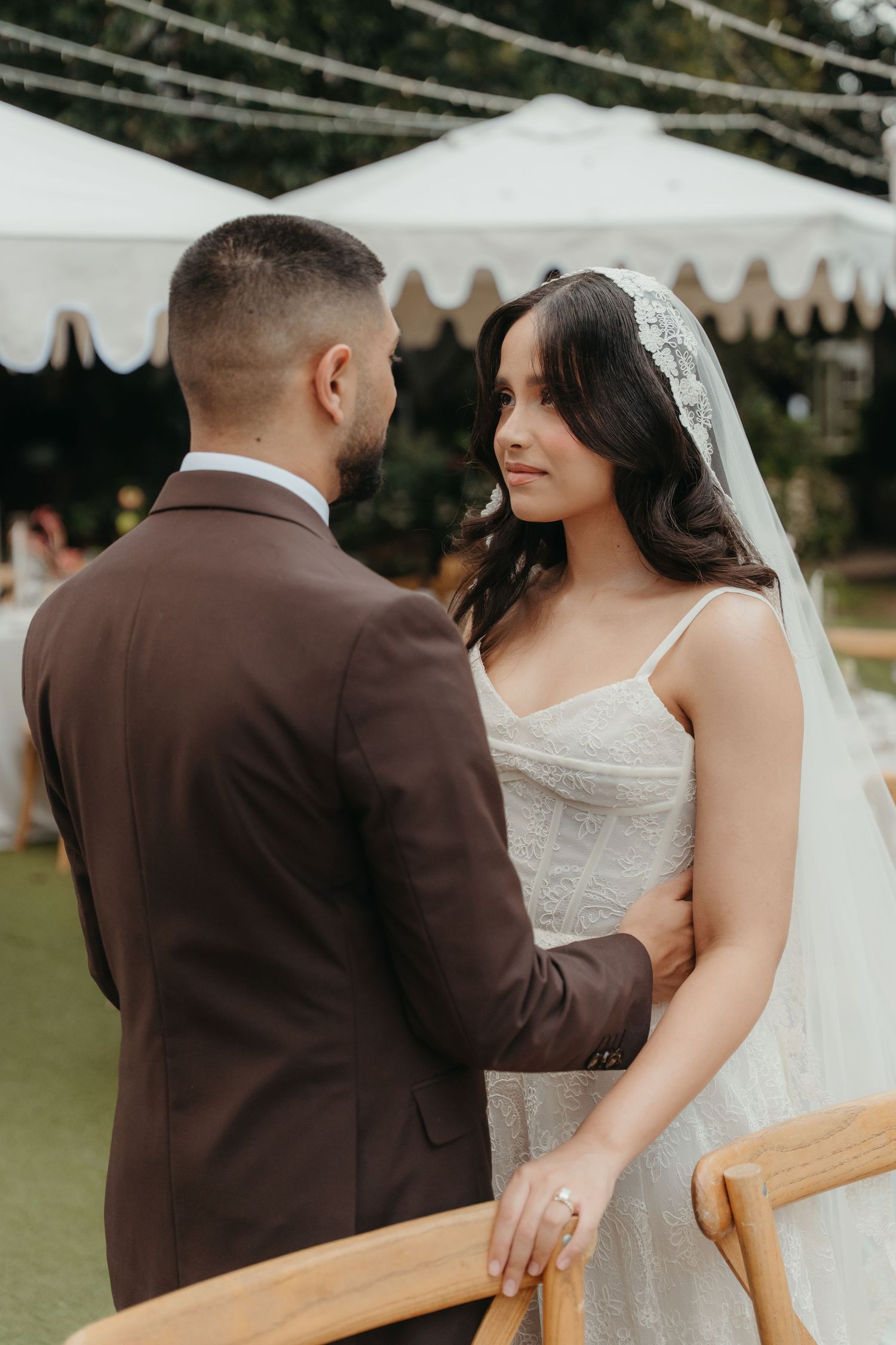 Bride in lace gown gazing at groom at outdoor garden wedding at Beechwood Gardens