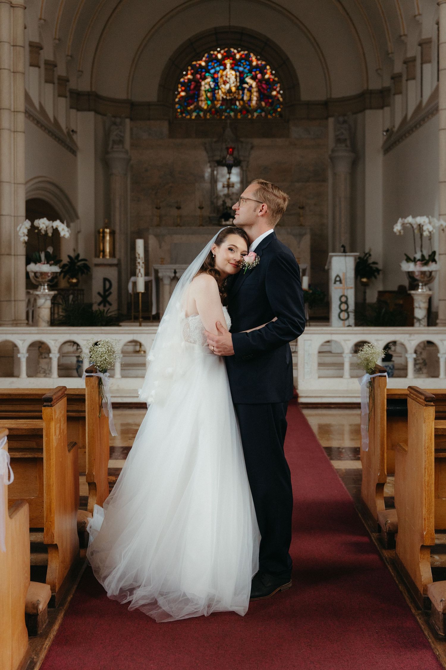 A romantic sequence of wedding photos showing a couple sharing intimate moments in a traditional church sanctuary at Nazareth House Chapel