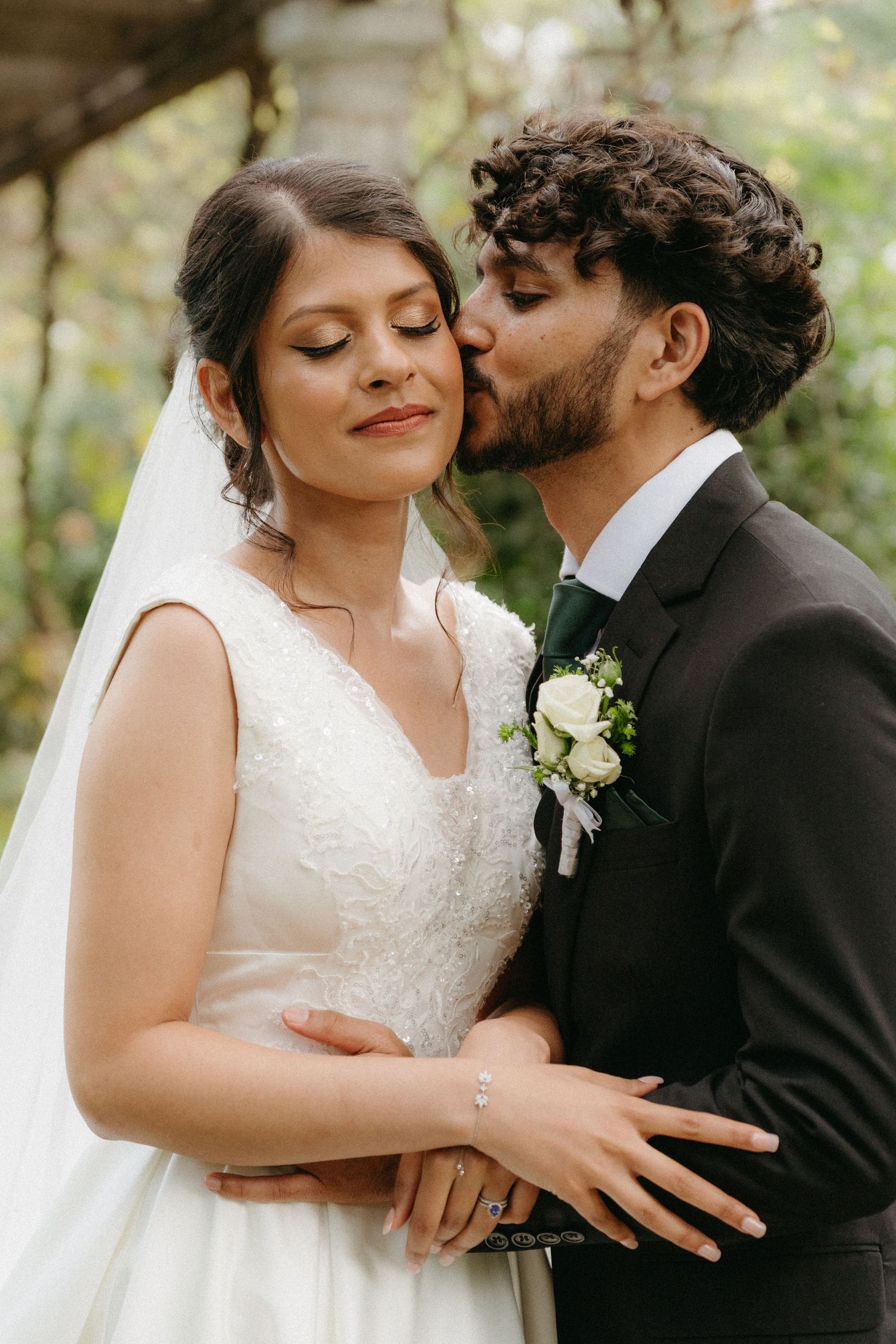 An intimate wedding couple moment captured in a series of romantic closeup shots amidst greenery.