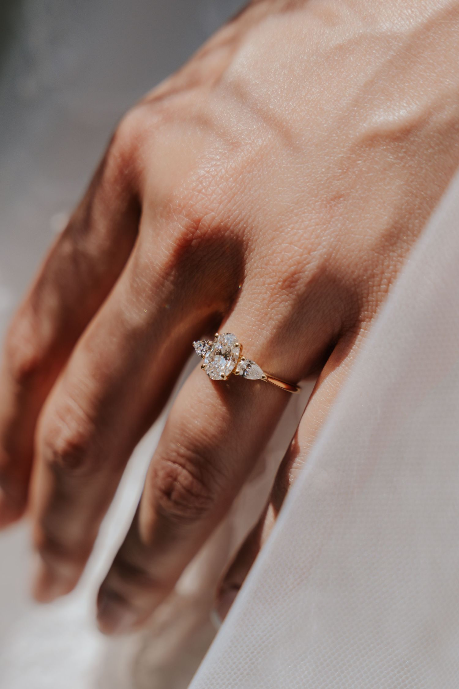 A series of close-up shots showing a diamond engagement ring on a person's hand from different angles.