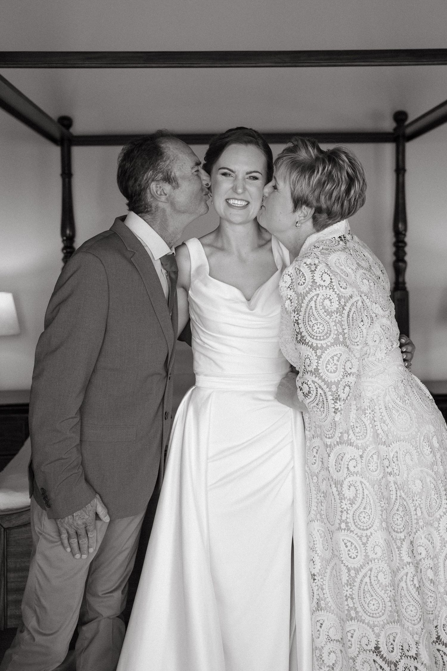 Black and white wedding photo series showing a couple in formal attire sharing intimate moments.