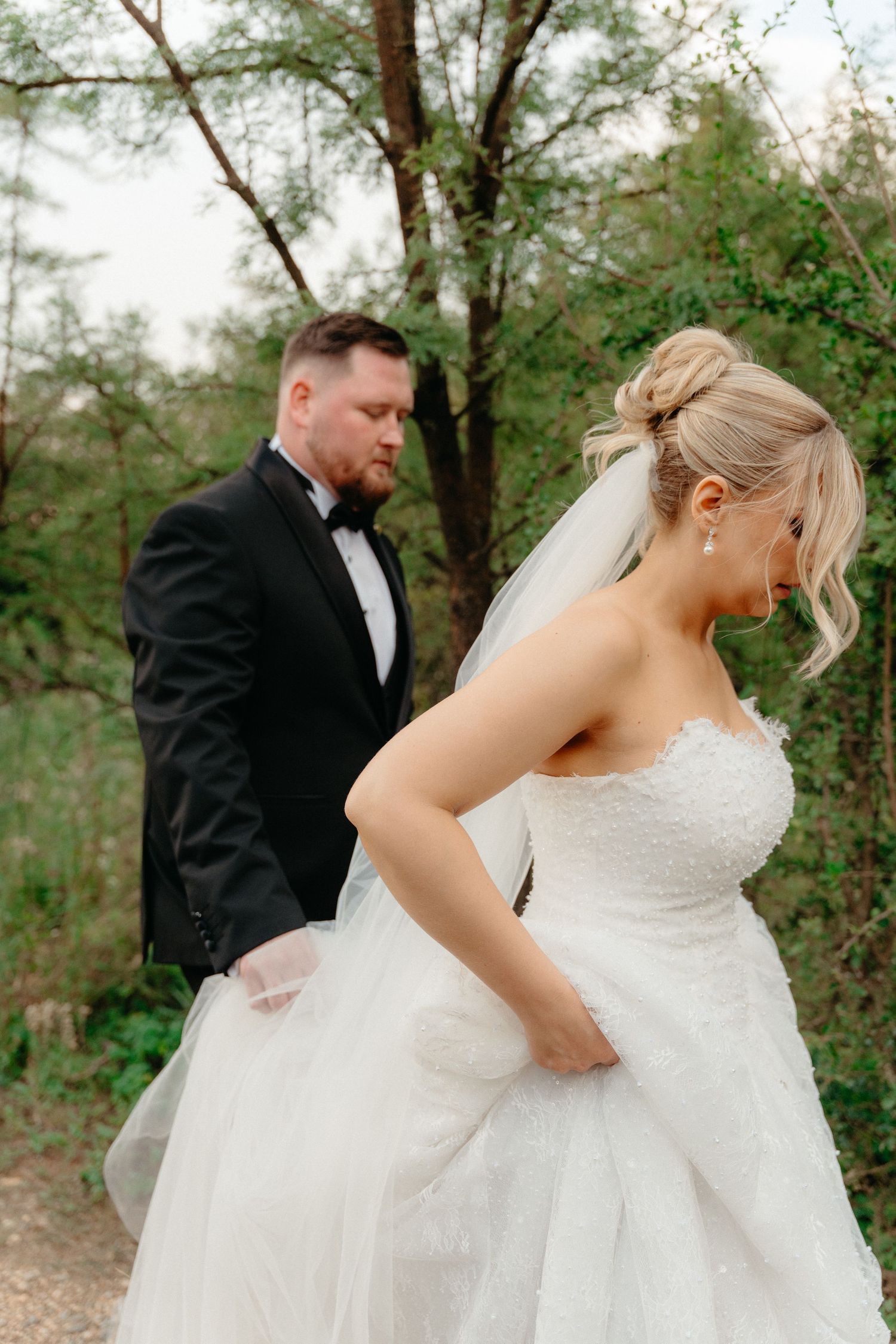 A series of candid wedding photos showing a couple dancing and twirling in a wooded outdoor setting.