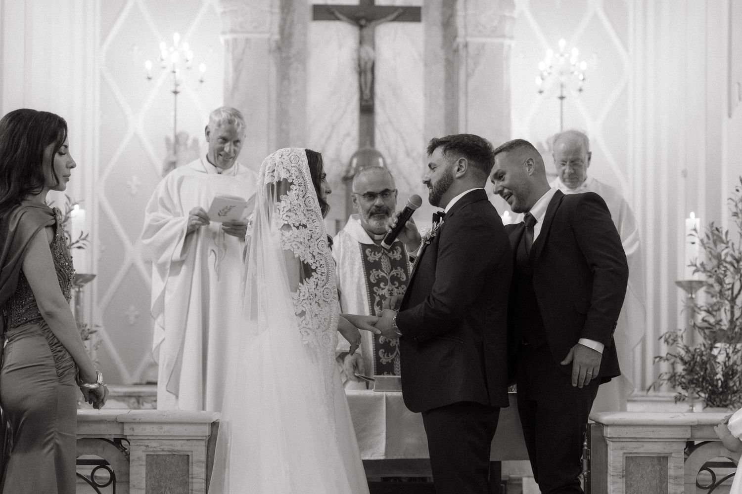 Black and white photo of a bride and groom exchanging vows at Rosebank Catholic Church