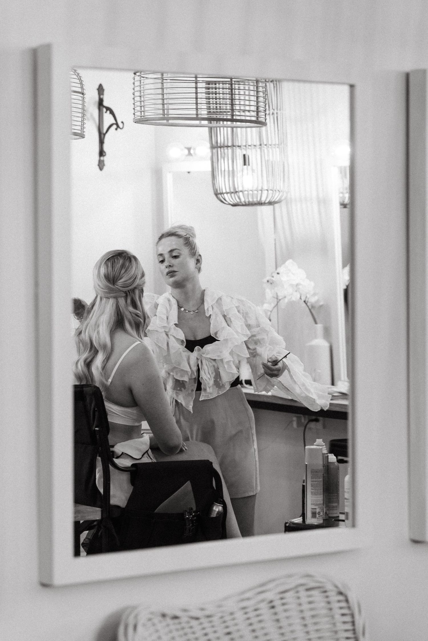 Black and white reflection of wedding preparations in series of mirrors.