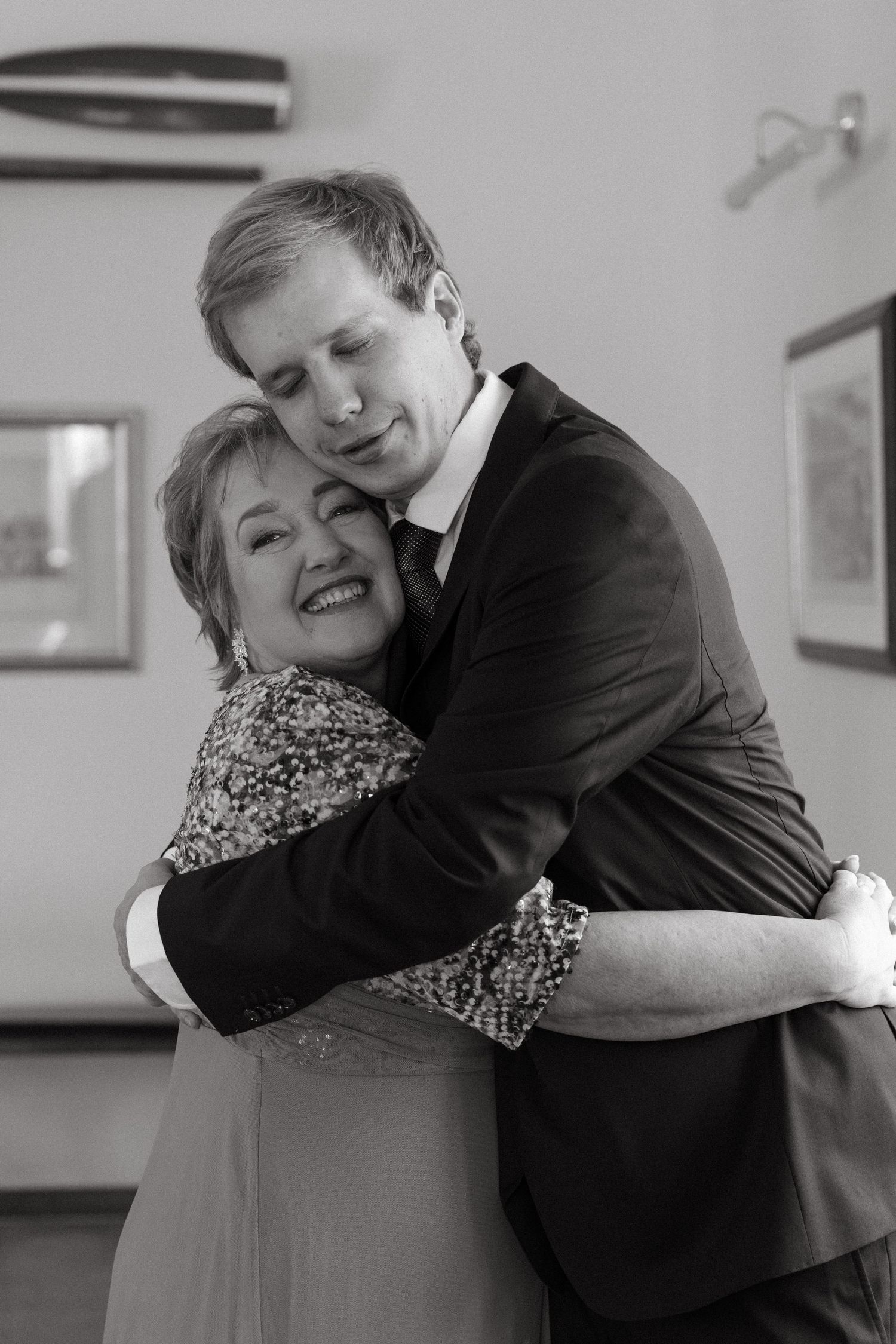 A touching black and white photo series showing an elderly woman and young person sharing warm embraces and smiles.