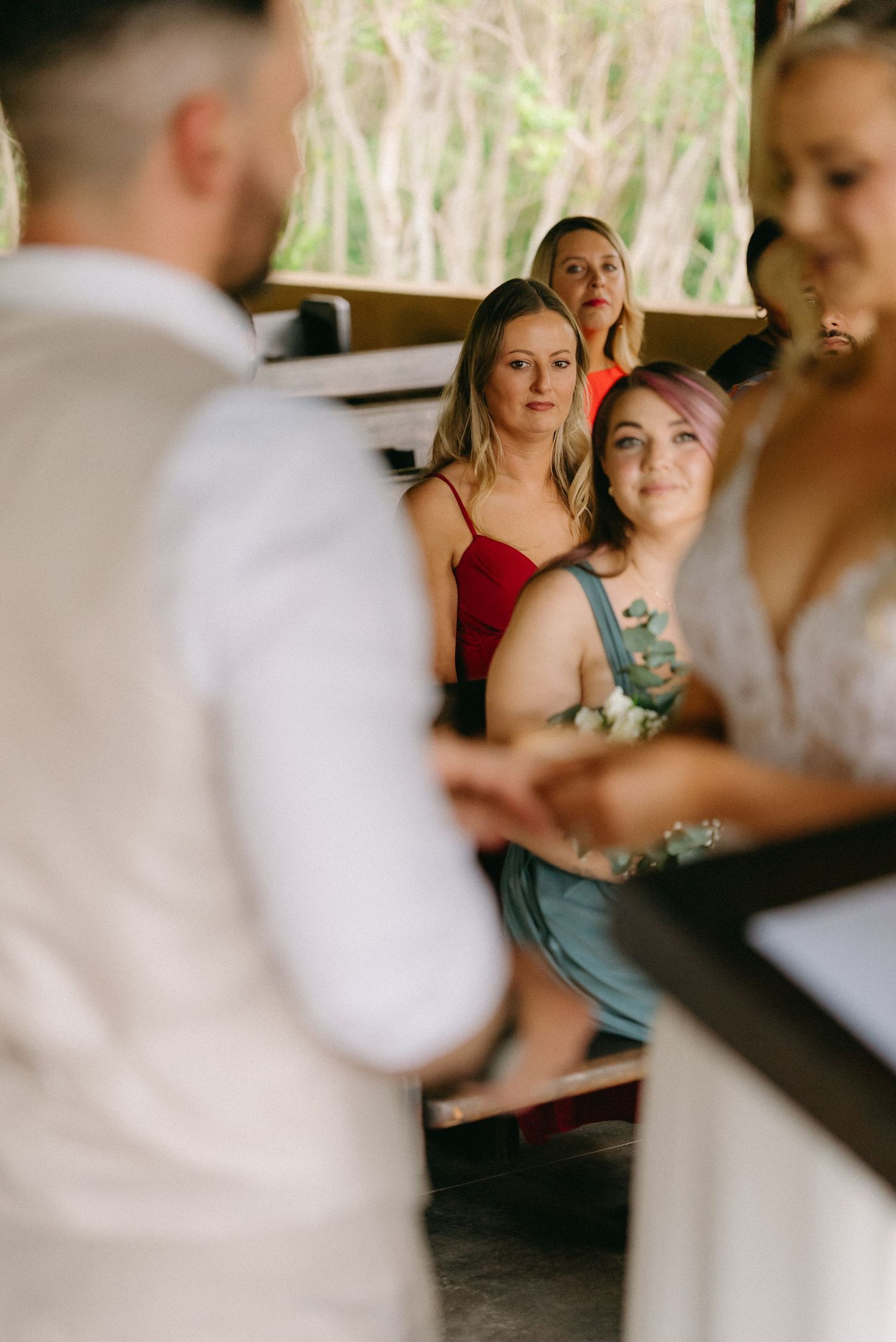 Wedding party gathered indoors during celebration with natural lighting.