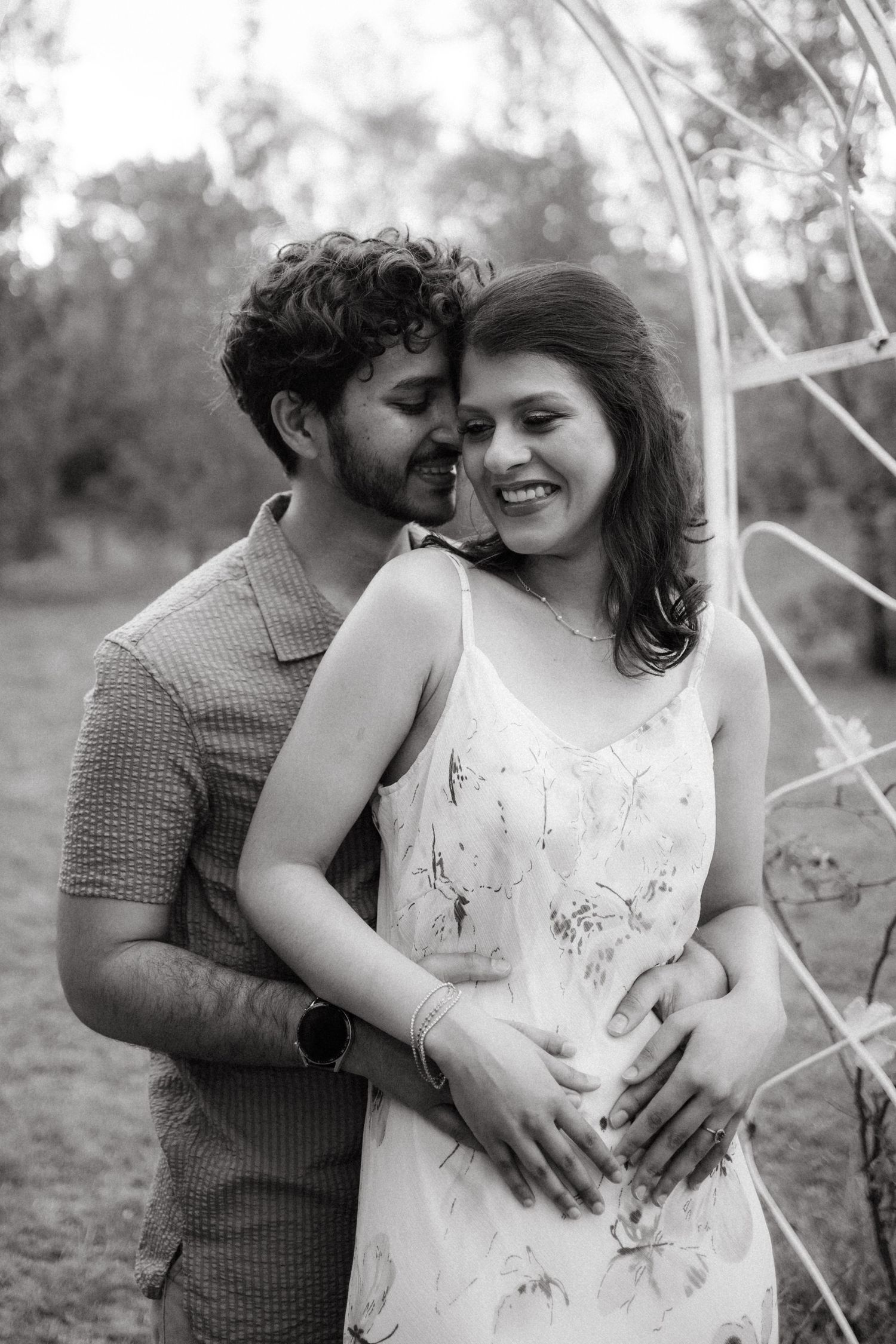 An intimate black and white portrait of a couple sharing a loving moment.