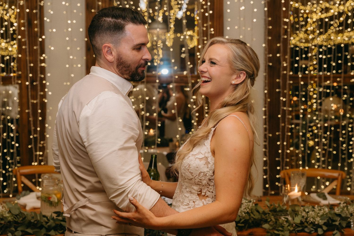 Dancing under warm twinkle lights at an elegant evening reception.