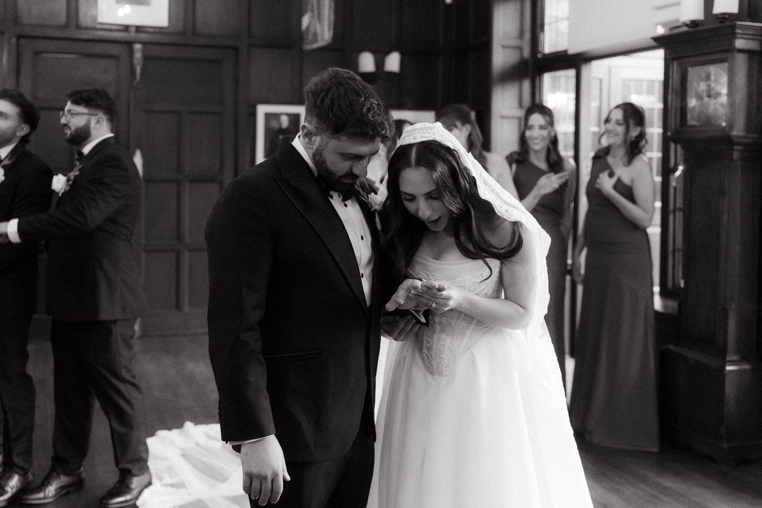 Black and white photo of bride and groom looking at their new rings rings at Glenshiel in Johannesburg