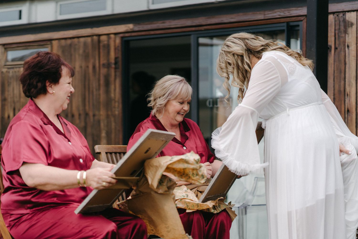 Wedding guests sharing a special moment while looking at something together.