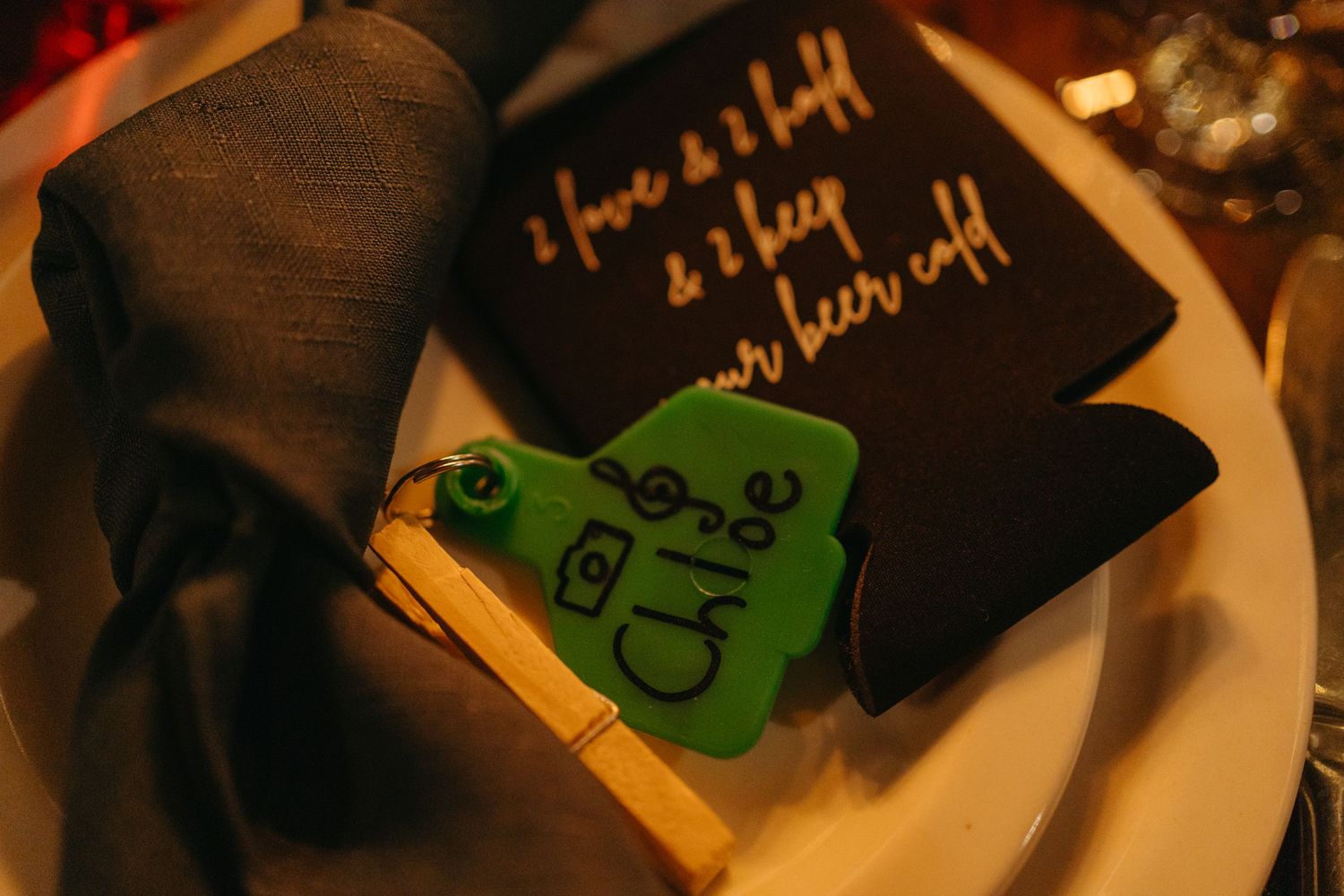 A close-up shot of a decorative place setting with a green ornament and napkin.