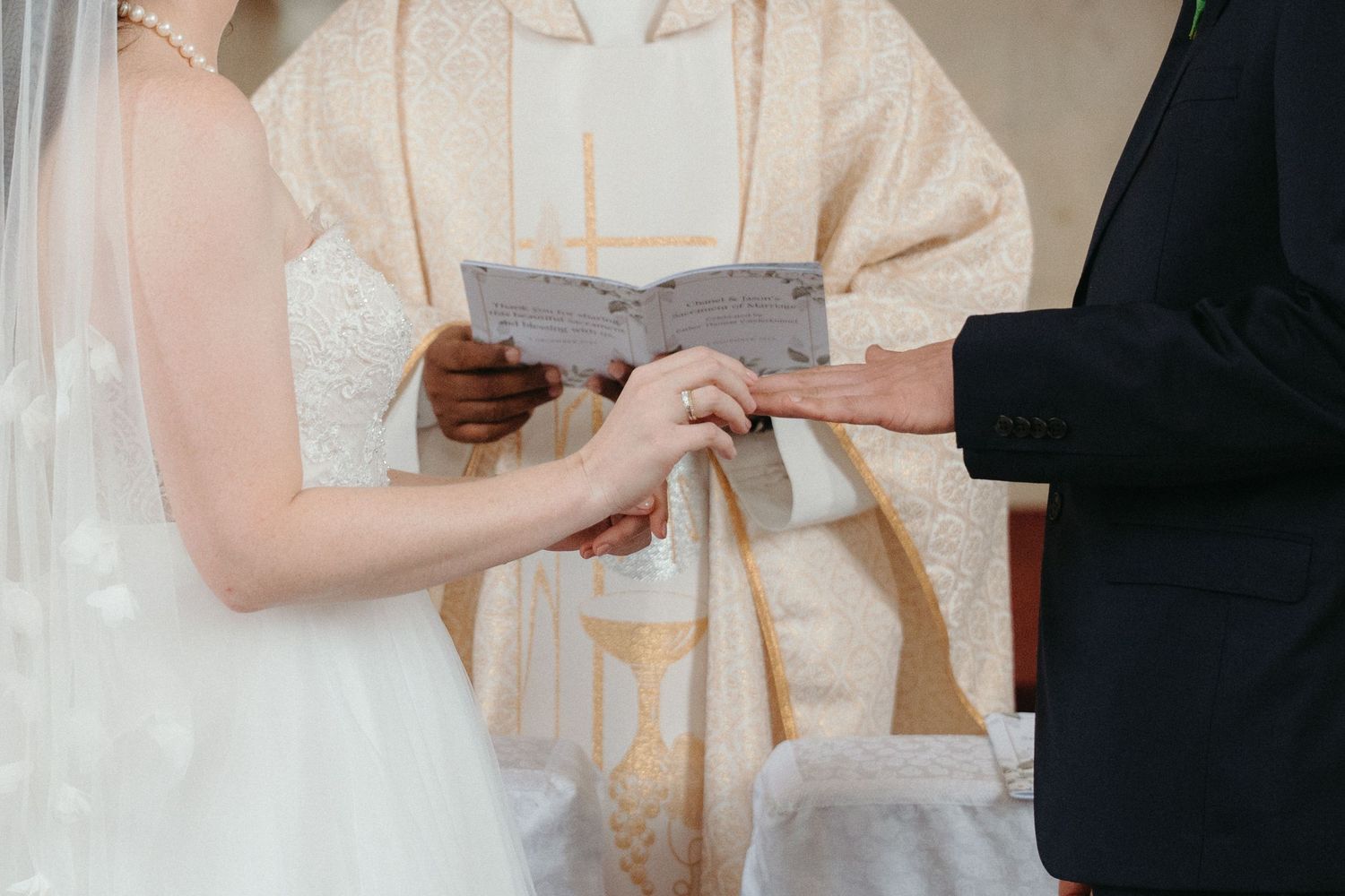 A bride and groom exchange rings in a Catholic wedding ceremony at Nazareth House Chapel