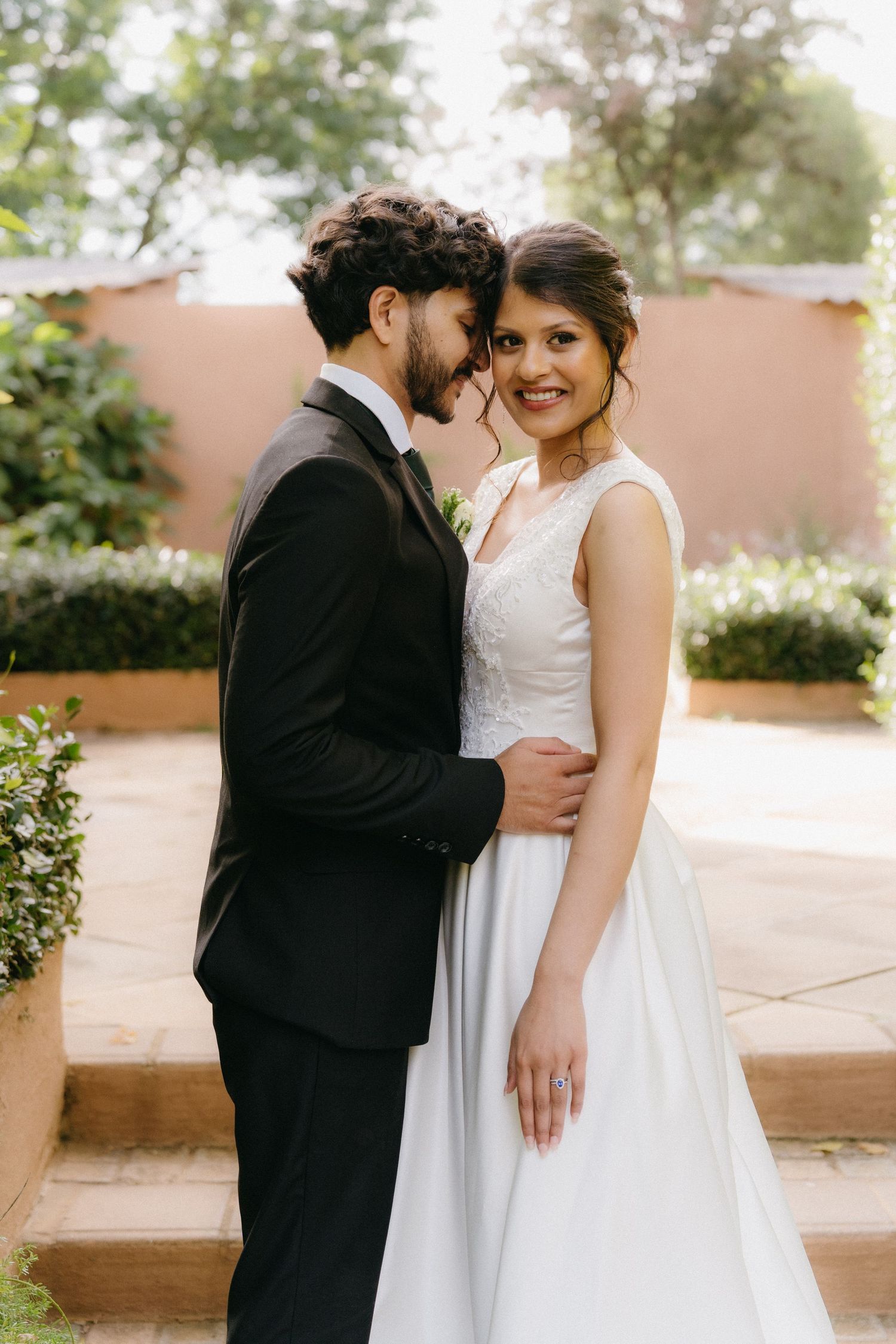 Romantic outdoor wedding sequence showing tender moments between newlyweds in formal attire at a rustic venue.