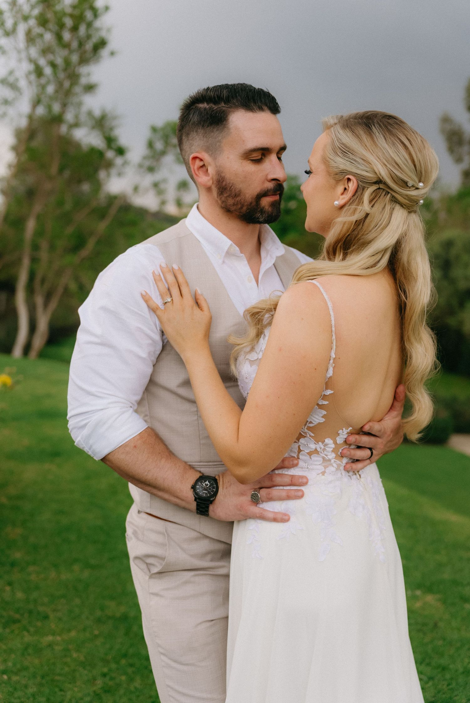 A romantic outdoor photo sequence showing a couple embracing in a lush green garden setting.