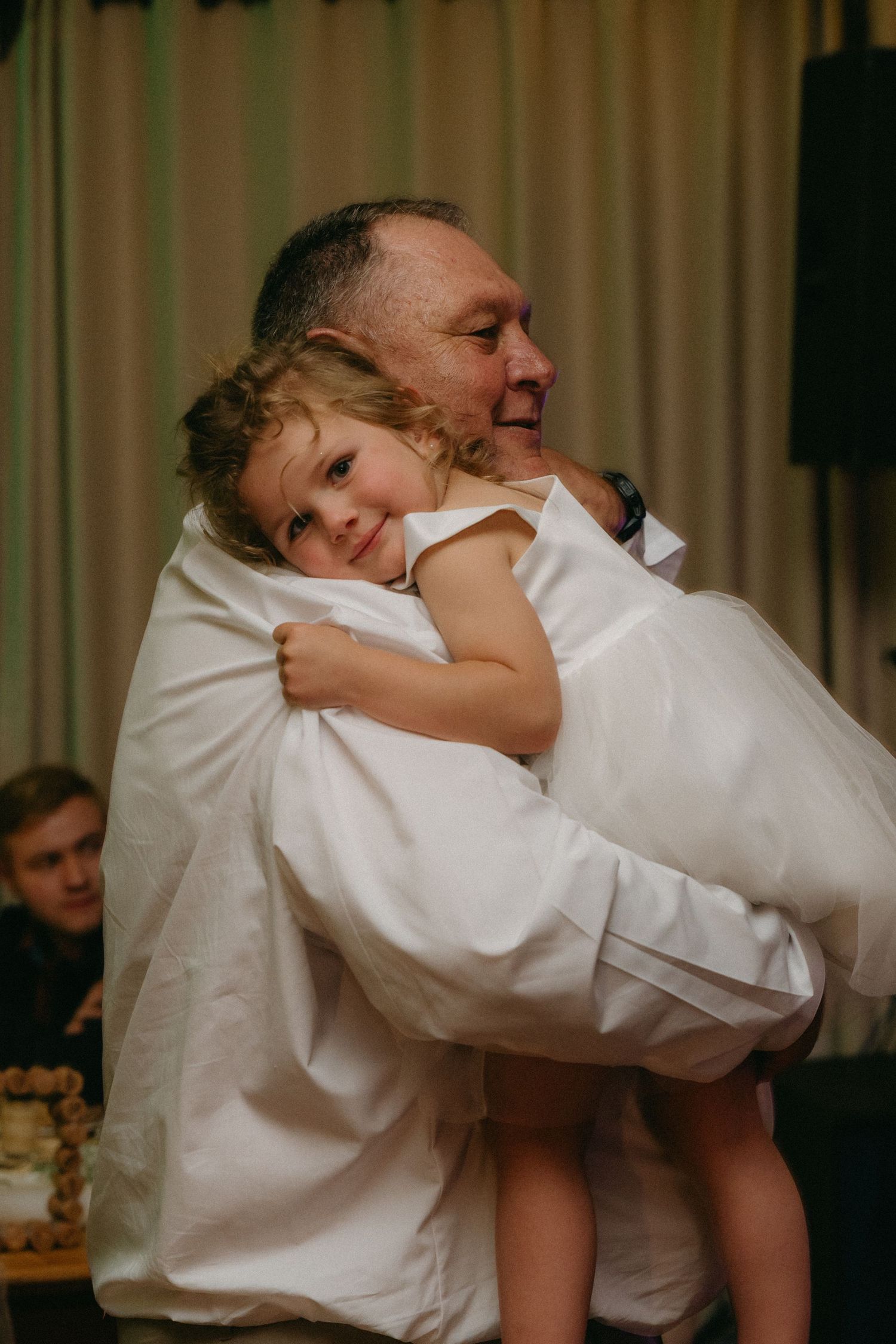 Playful dance moves being performed during a wedding reception celebration.