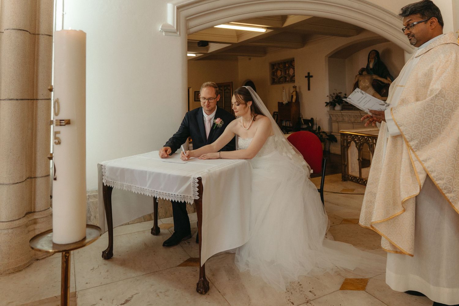 Bride and groom sign the wedding register at Nazareth House Chapel in Pretoria